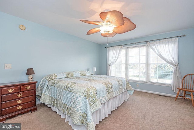 bedroom with ceiling fan and light colored carpet