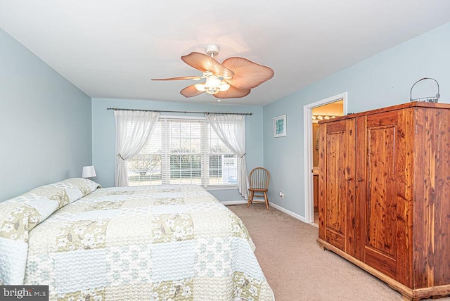 bedroom with light colored carpet and ceiling fan