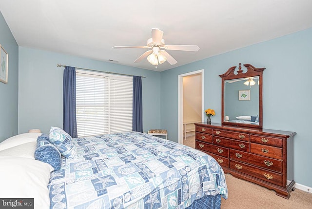 bedroom with light carpet and ceiling fan