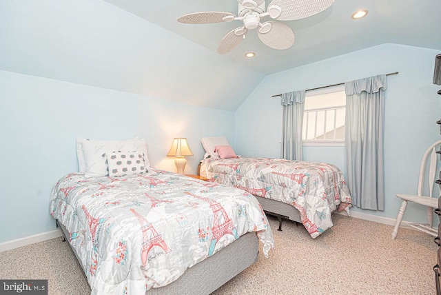 carpeted bedroom with ceiling fan and vaulted ceiling