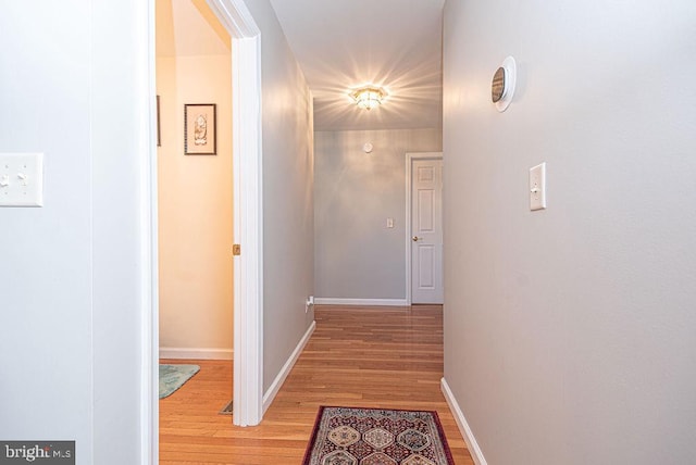 corridor with hardwood / wood-style floors