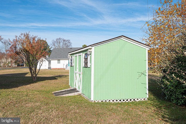 view of outbuilding with a yard