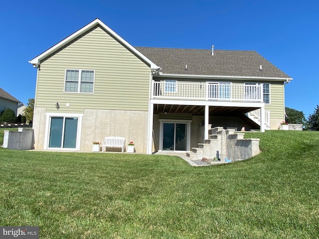 back of house featuring a yard and a wooden deck