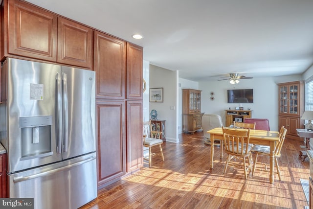 kitchen with stainless steel fridge, light hardwood / wood-style floors, and ceiling fan