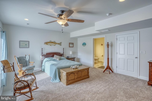 bedroom featuring carpet flooring, ensuite bath, and ceiling fan