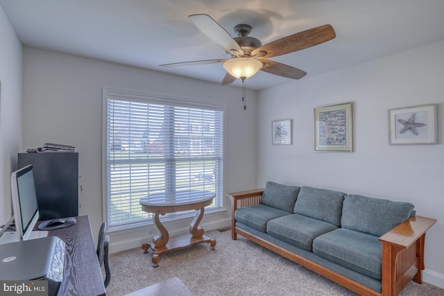 carpeted living room with ceiling fan and a healthy amount of sunlight