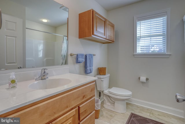 bathroom featuring a shower with curtain, vanity, toilet, and tile patterned floors