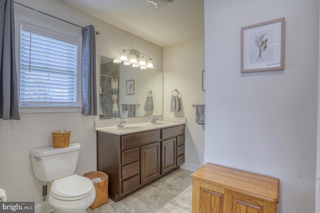 bathroom featuring a shower, vanity, and toilet