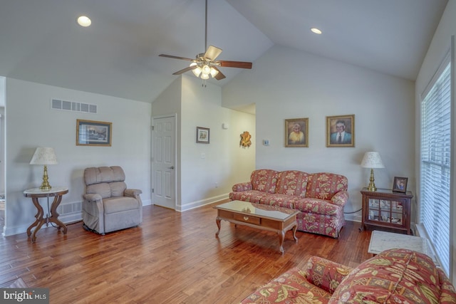 living room with hardwood / wood-style floors, high vaulted ceiling, and ceiling fan