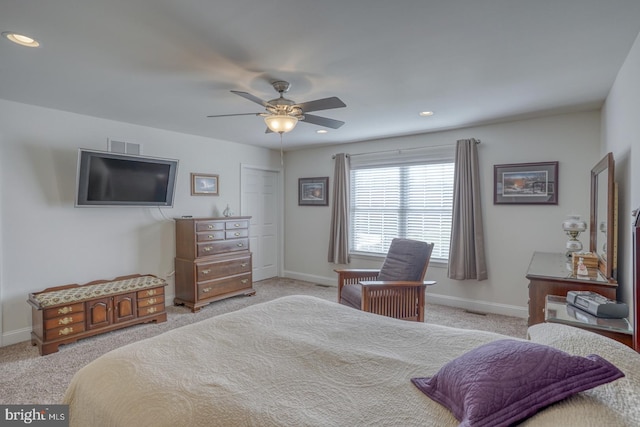 carpeted bedroom with ceiling fan and a closet