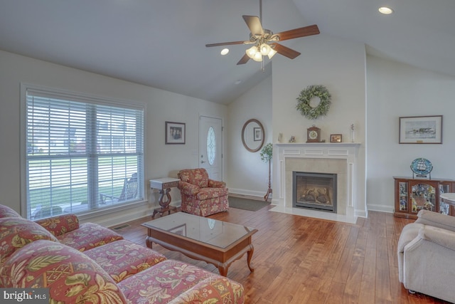 living room with ceiling fan, high vaulted ceiling, and light hardwood / wood-style floors