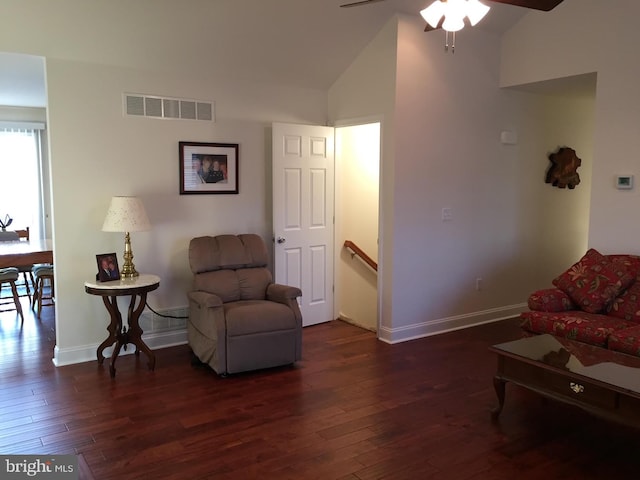 living area with ceiling fan, dark hardwood / wood-style flooring, and lofted ceiling