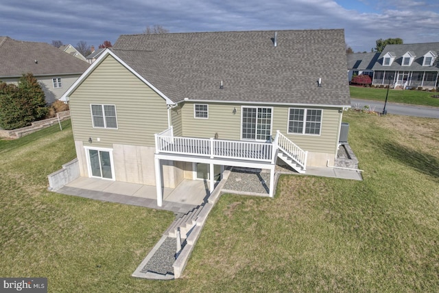 rear view of property with a patio area, a yard, and a deck