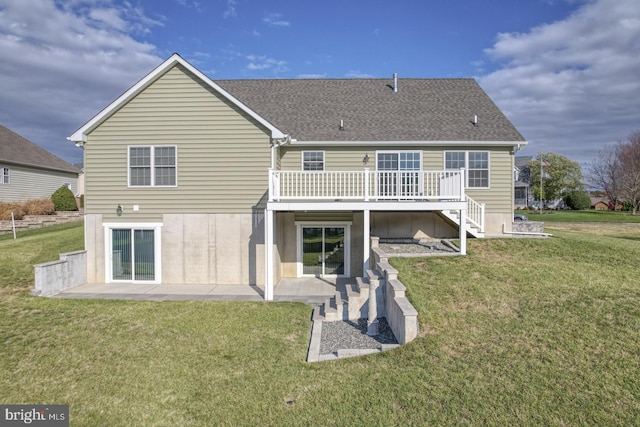 rear view of property with a yard and a wooden deck