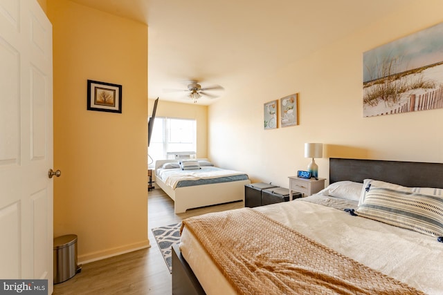 bedroom featuring ceiling fan and dark hardwood / wood-style flooring