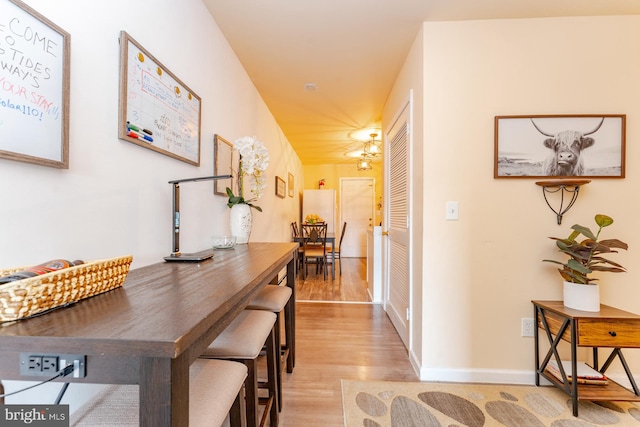 hallway with light hardwood / wood-style floors