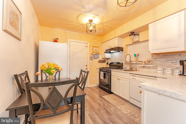 kitchen featuring decorative backsplash, white cabinets, light hardwood / wood-style floors, and white appliances