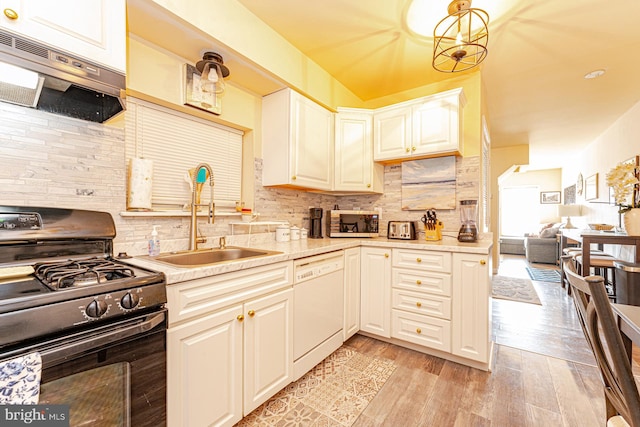 kitchen with gas stove, dishwasher, sink, light hardwood / wood-style floors, and exhaust hood