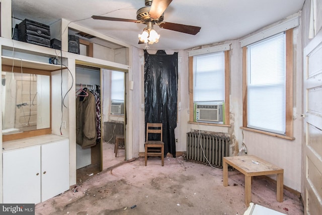 bedroom featuring radiator heating unit, cooling unit, and ceiling fan