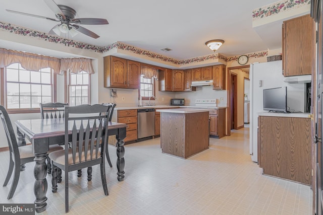 kitchen featuring a center island, stainless steel dishwasher, ceiling fan, and sink