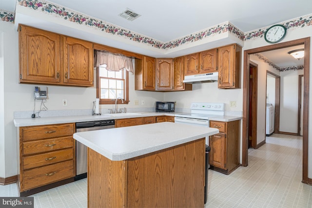 kitchen featuring dishwasher, sink, white range with electric stovetop, washer / dryer, and a kitchen island