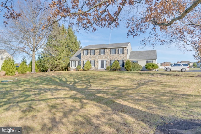 colonial-style house with a front lawn