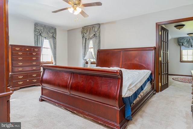 bedroom featuring light colored carpet and ceiling fan