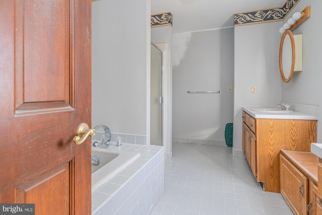 bathroom with vanity, tile patterned floors, and independent shower and bath