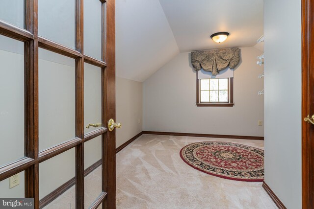 bonus room featuring light carpet and lofted ceiling