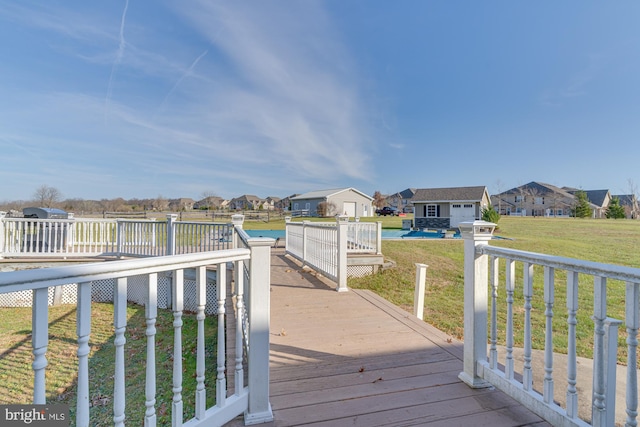 wooden deck featuring a yard and an outdoor structure