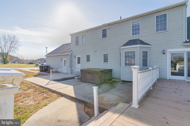 back of property featuring a wooden deck