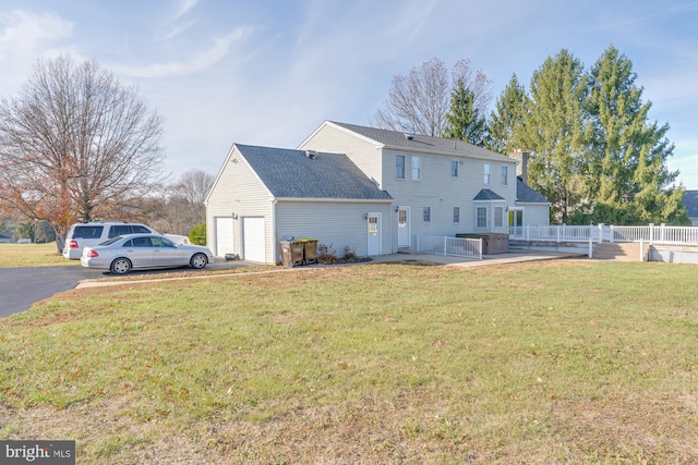 rear view of house featuring a yard