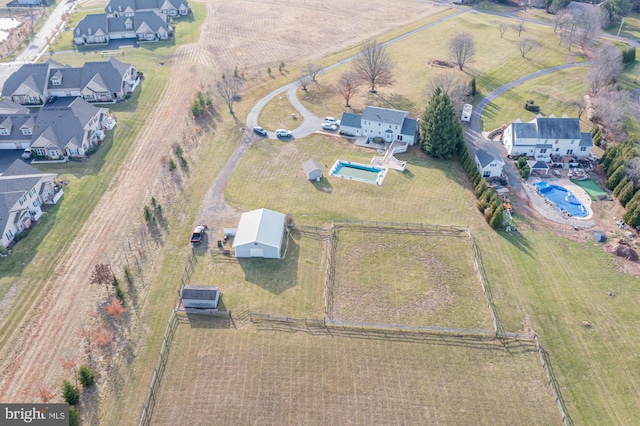 birds eye view of property with a rural view