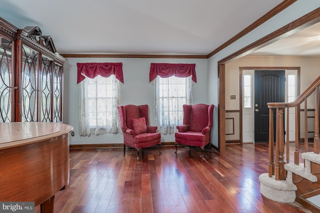 living area featuring dark hardwood / wood-style floors and crown molding