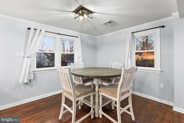 dining space featuring a healthy amount of sunlight, dark hardwood / wood-style flooring, and crown molding