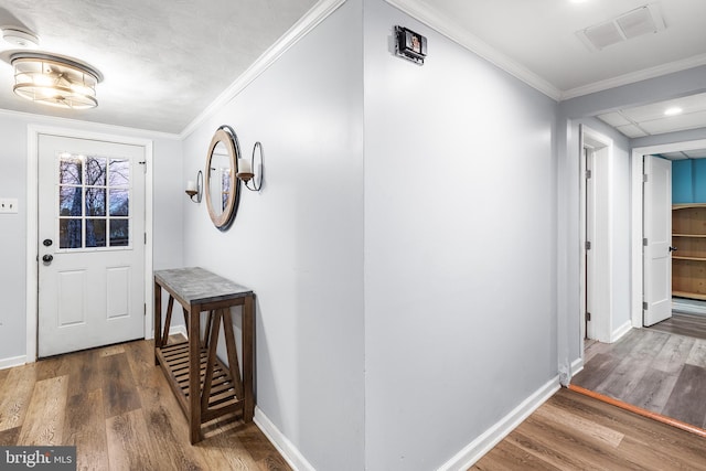 foyer entrance with dark hardwood / wood-style floors and ornamental molding