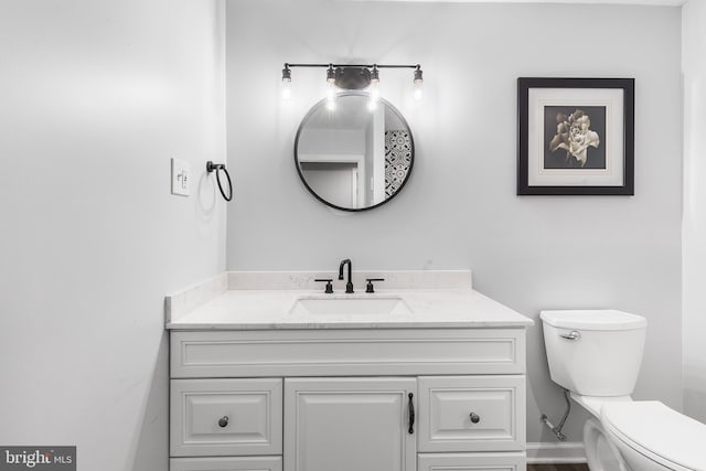 bathroom featuring vanity and toilet