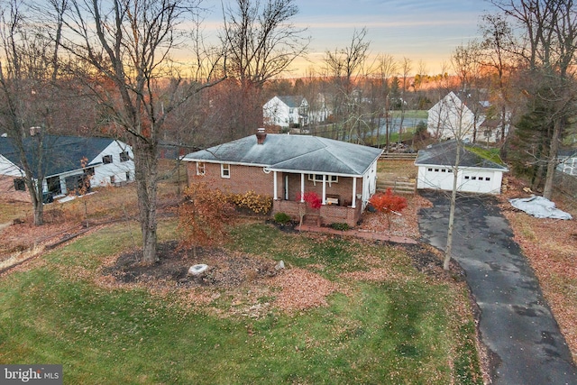 view of front of house with an outbuilding, covered porch, and a garage