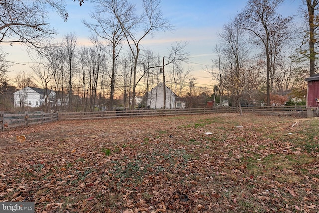 view of yard at dusk