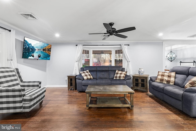 living room with ceiling fan with notable chandelier, dark hardwood / wood-style floors, and crown molding