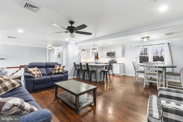 living room featuring dark hardwood / wood-style floors and ceiling fan