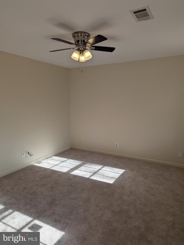 spare room featuring ceiling fan and light colored carpet