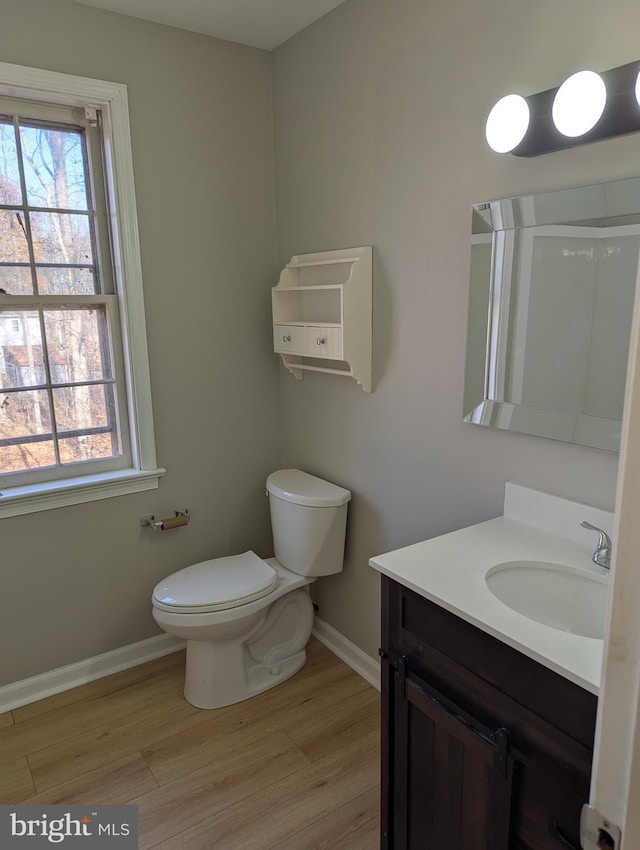 bathroom featuring hardwood / wood-style flooring, vanity, and toilet