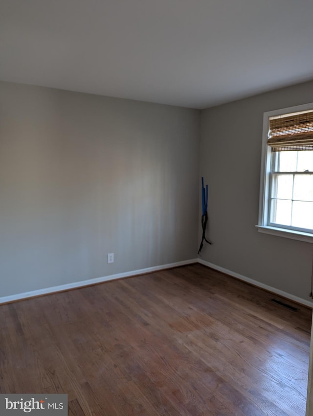 empty room with hardwood / wood-style floors