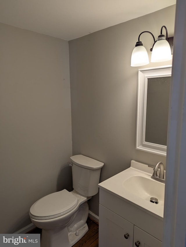 bathroom featuring hardwood / wood-style floors, vanity, and toilet