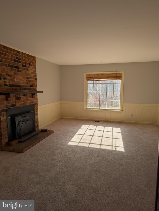 unfurnished living room featuring carpet