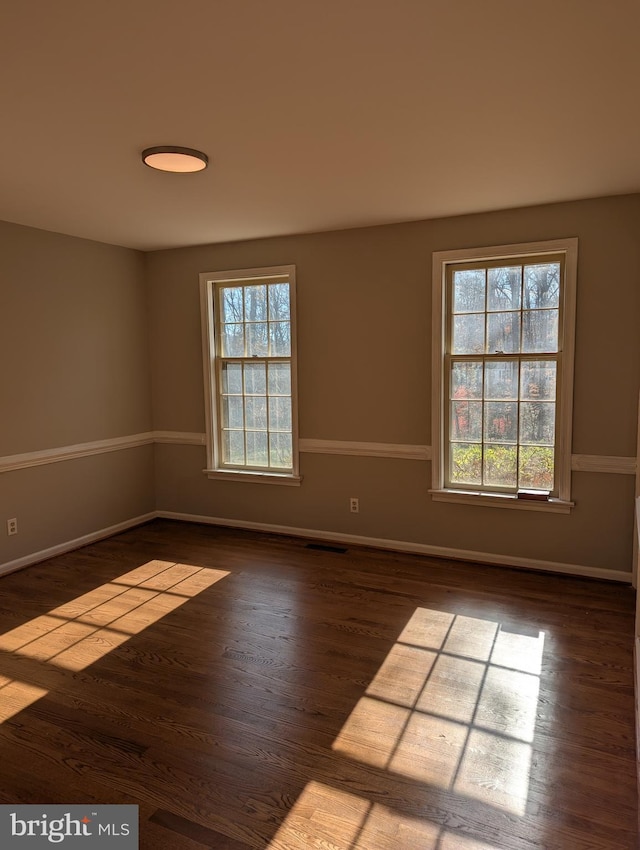 spare room featuring dark hardwood / wood-style floors