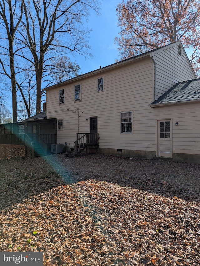 rear view of house featuring central AC