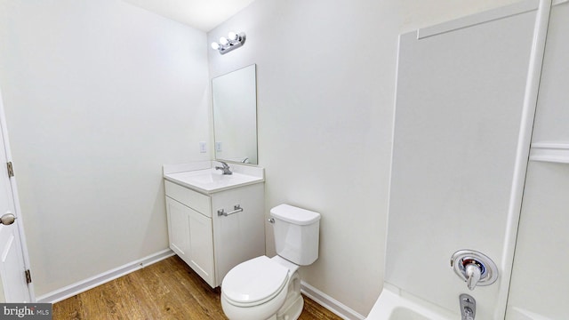 bathroom with vanity, hardwood / wood-style flooring, and toilet