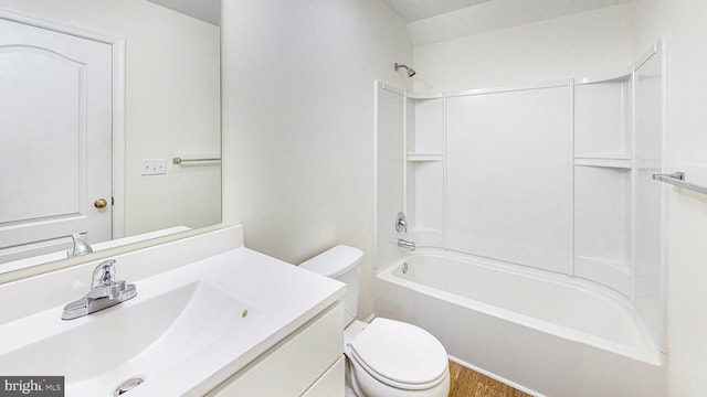 full bathroom with hardwood / wood-style floors, vanity, shower / bath combination, and toilet